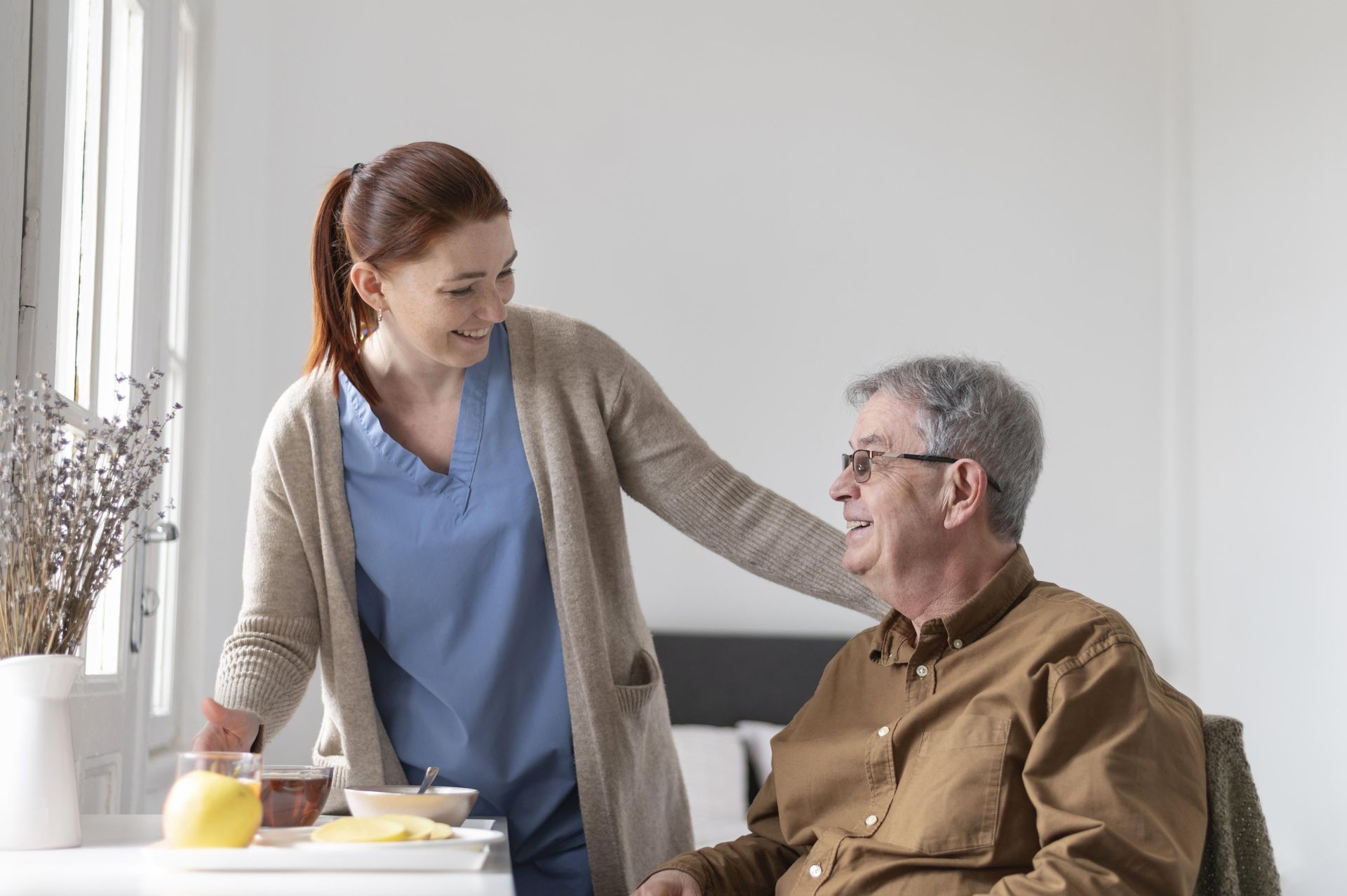 Personal support worker caring an old man at home.